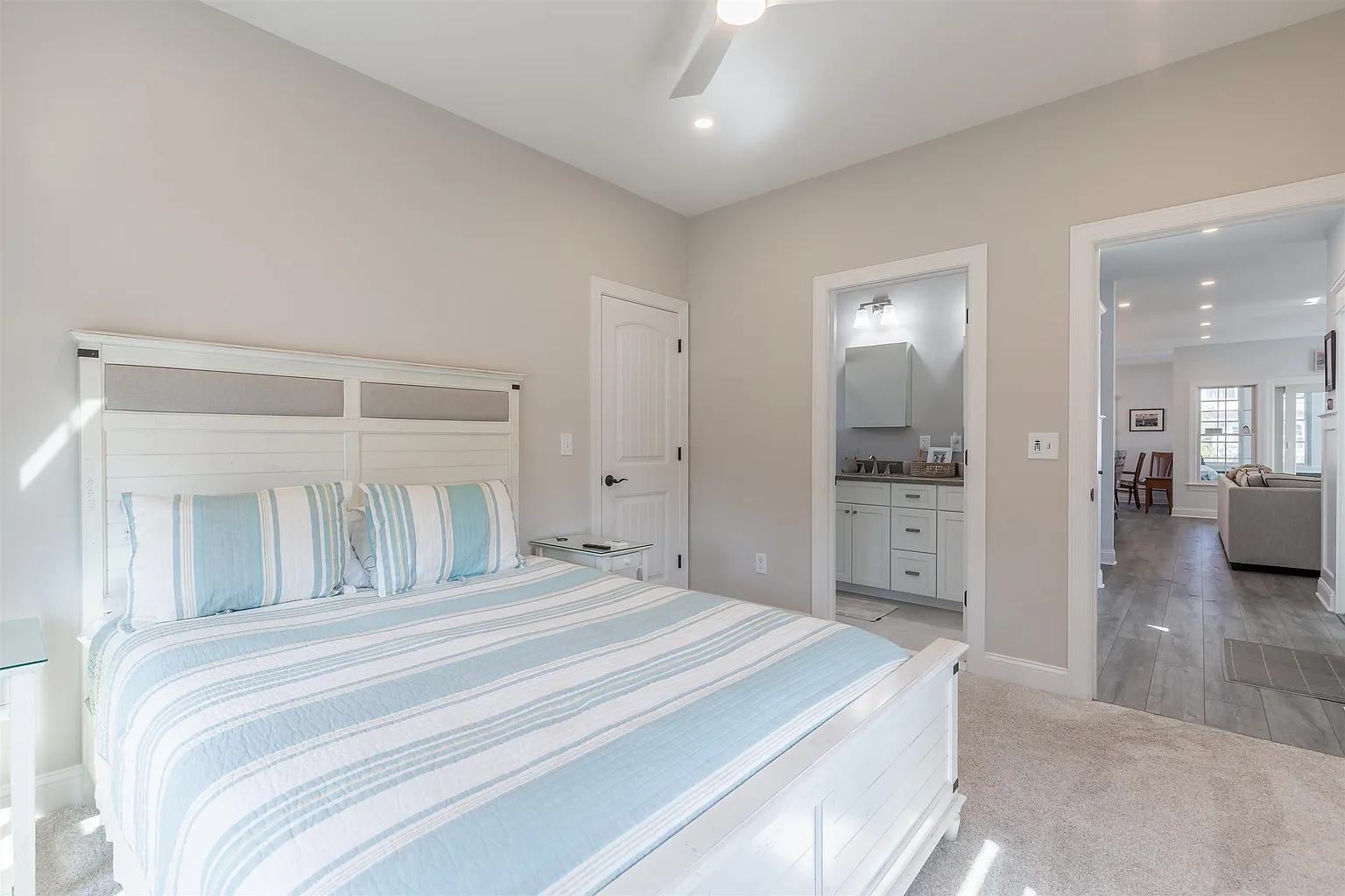Bedroom with striped bedding and ensuite.