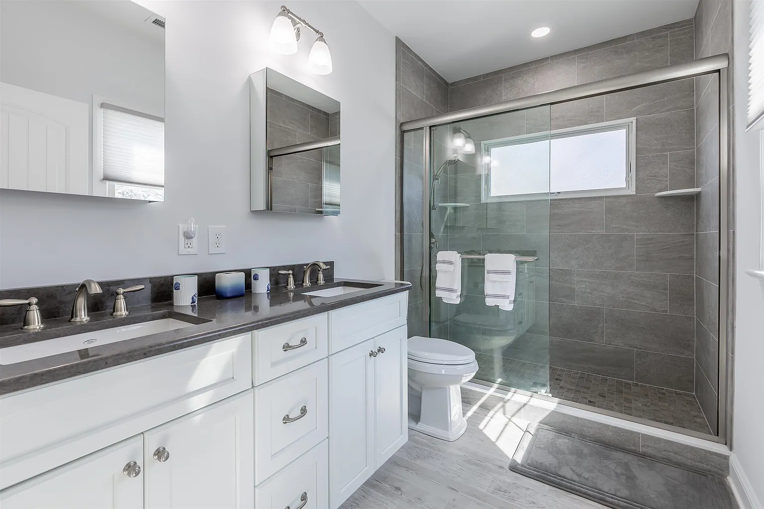 Modern bathroom with double vanity and shower.