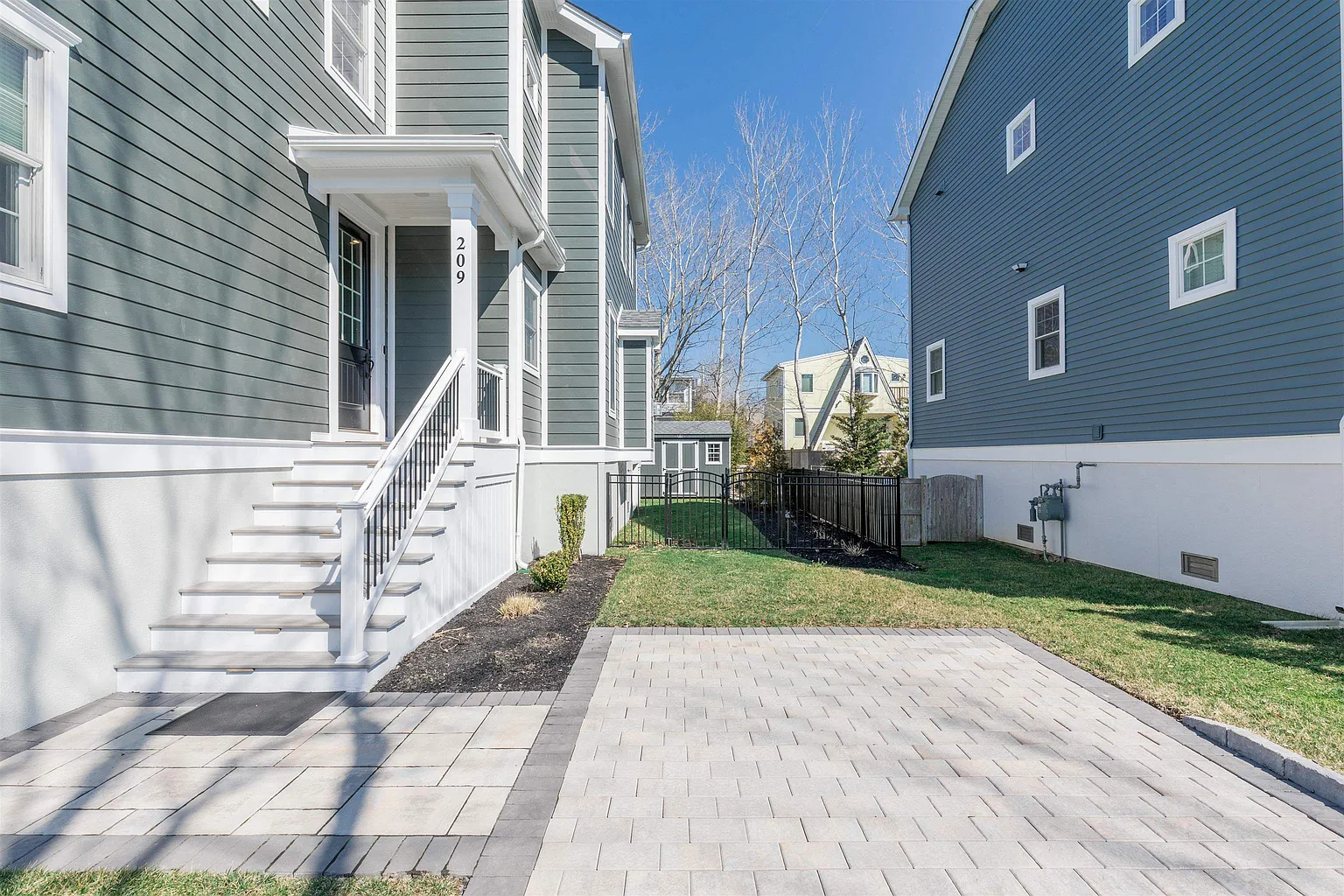 House exterior with paved patio and steps.