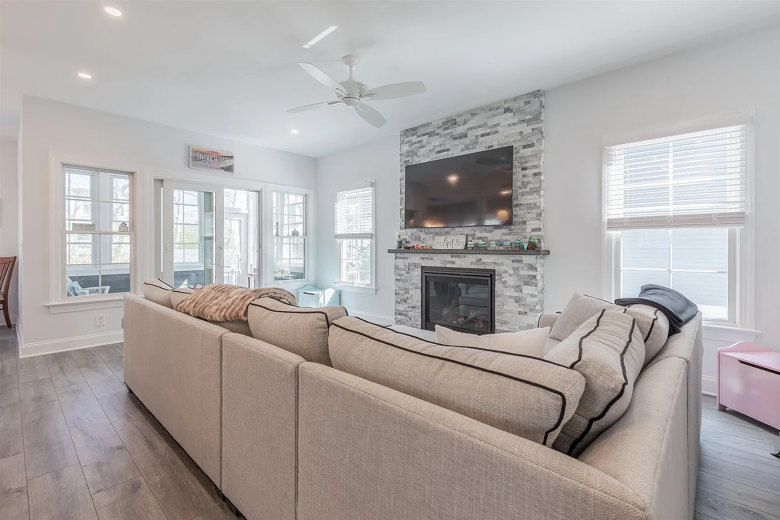Living room with sectional sofa and fireplace.