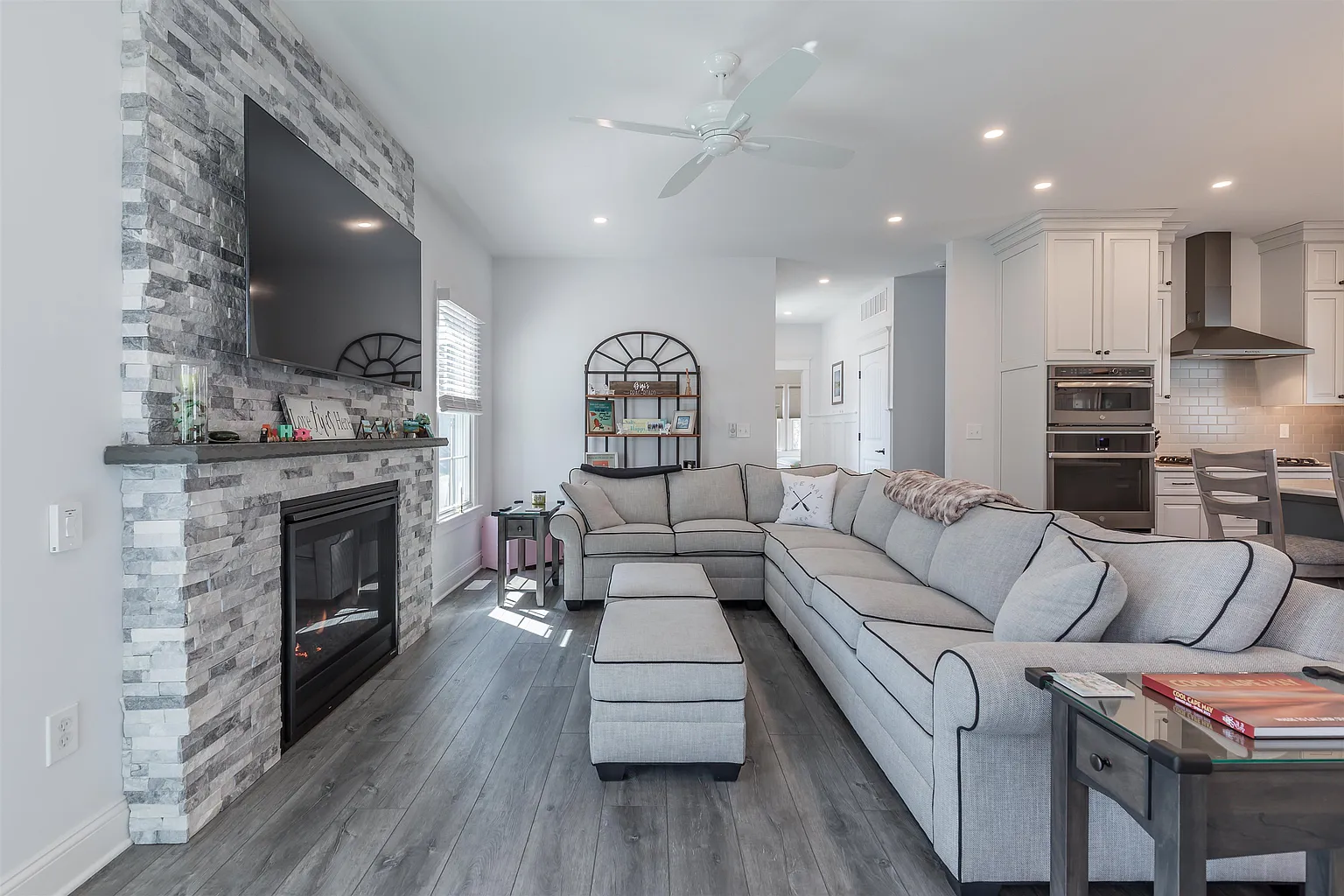 Modern living room with stone fireplace.