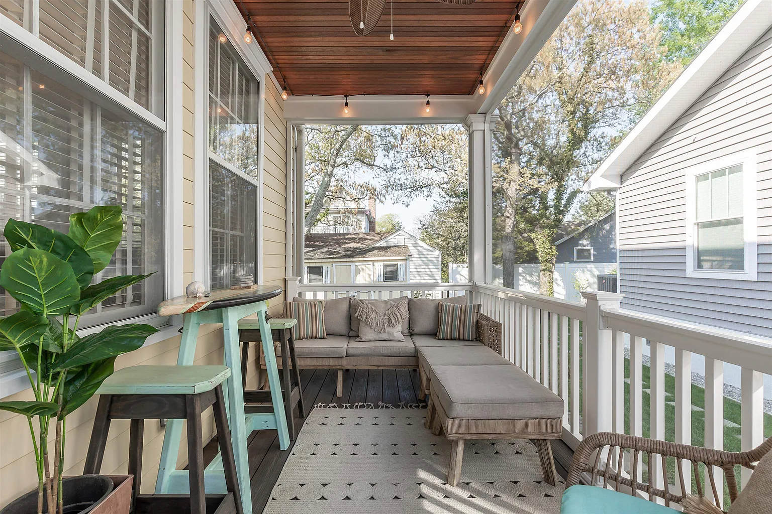 Screened porch with comfy seating area.