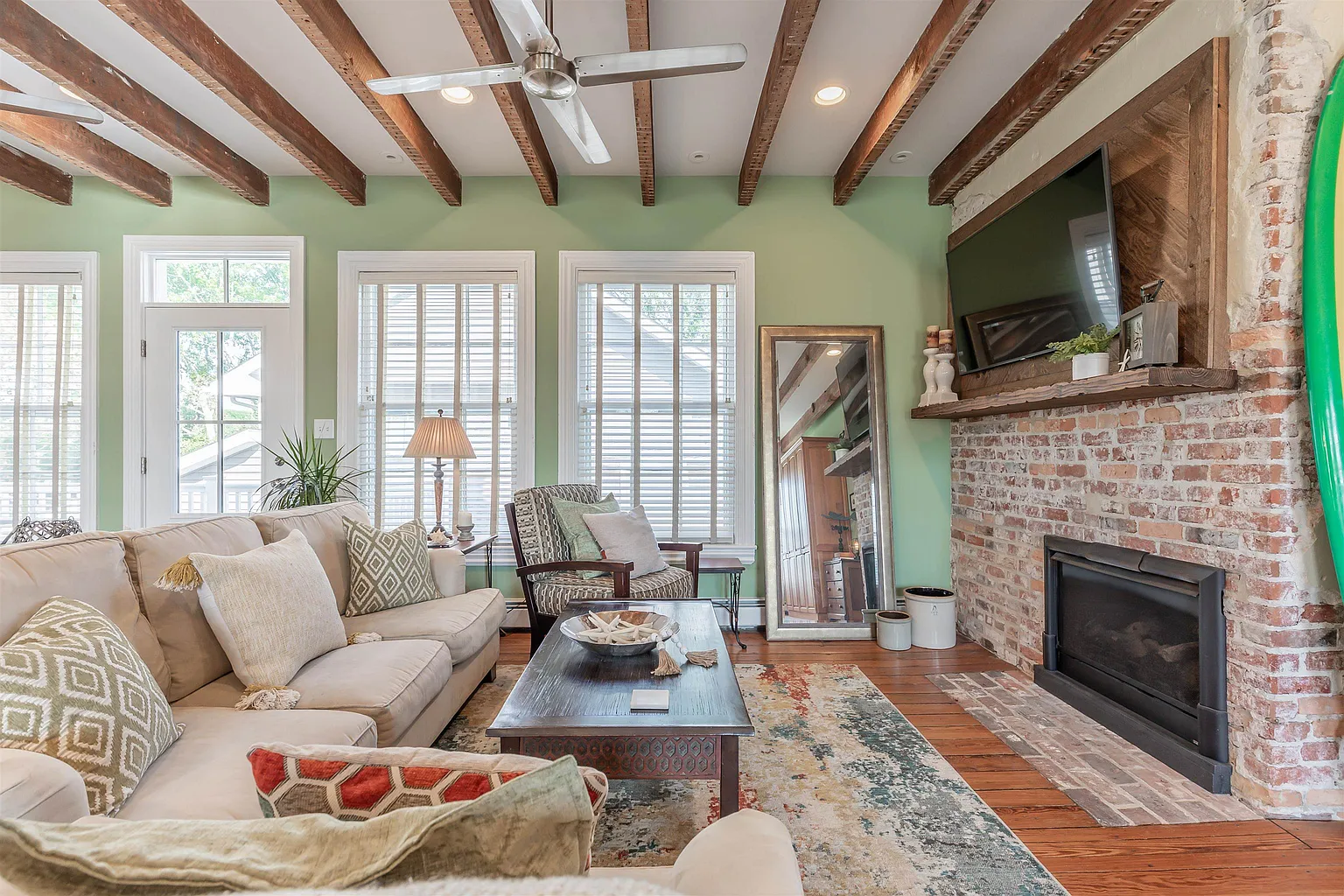 Rustic living room with fireplace and exposed beams.
