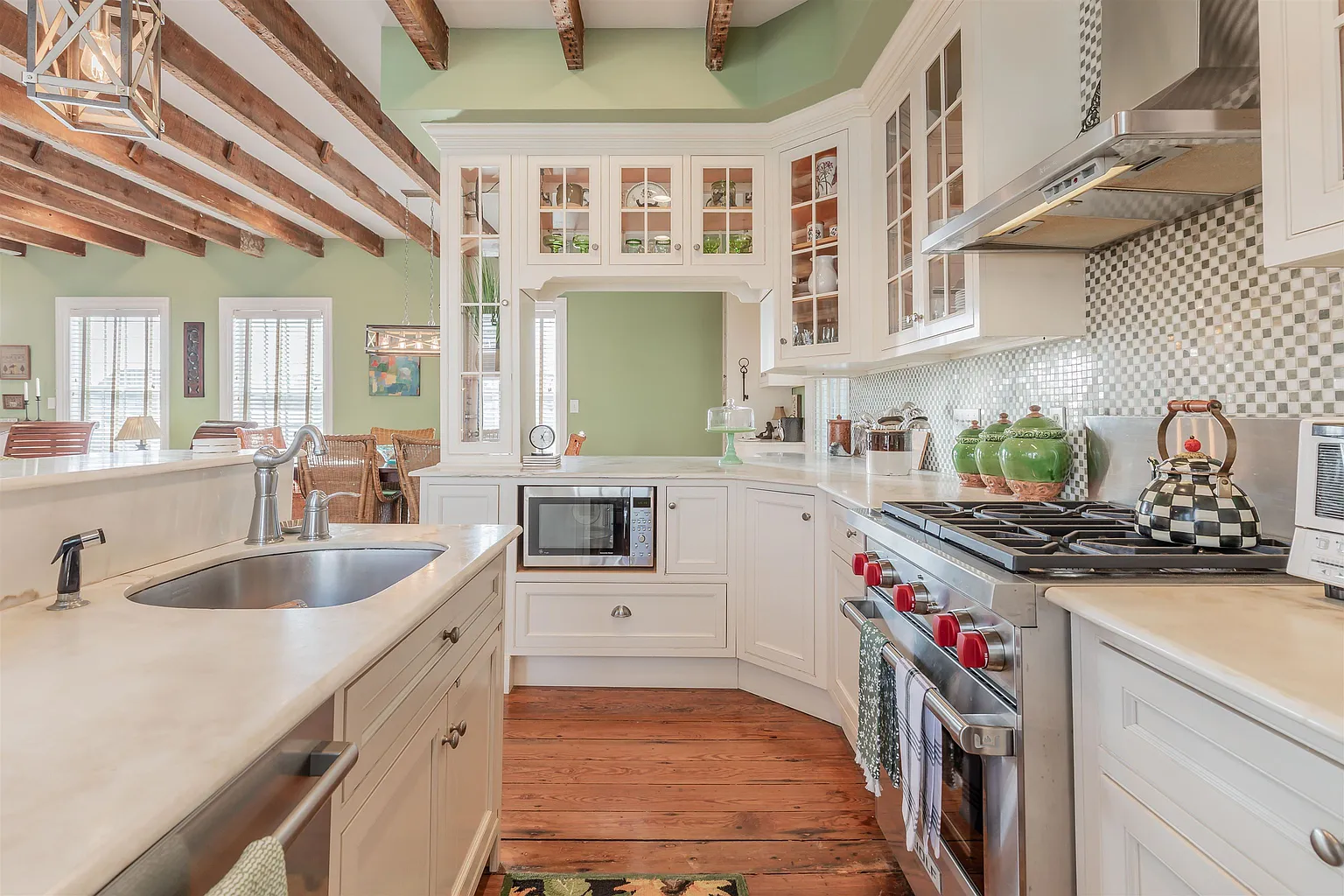 Bright white kitchen with exposed beams.