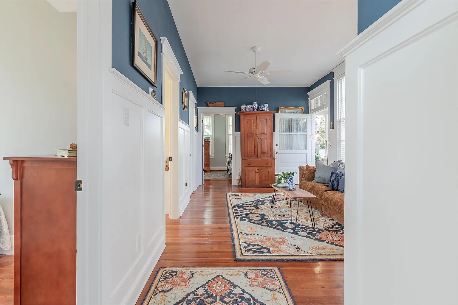 Hallway to living room with blue walls.