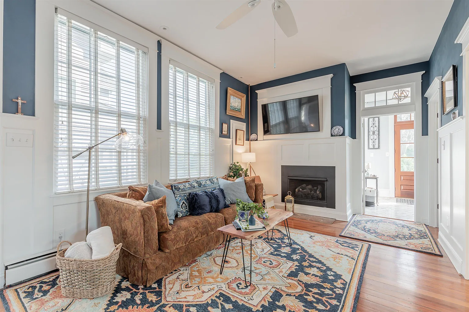 Cozy living room with fireplace and rug.