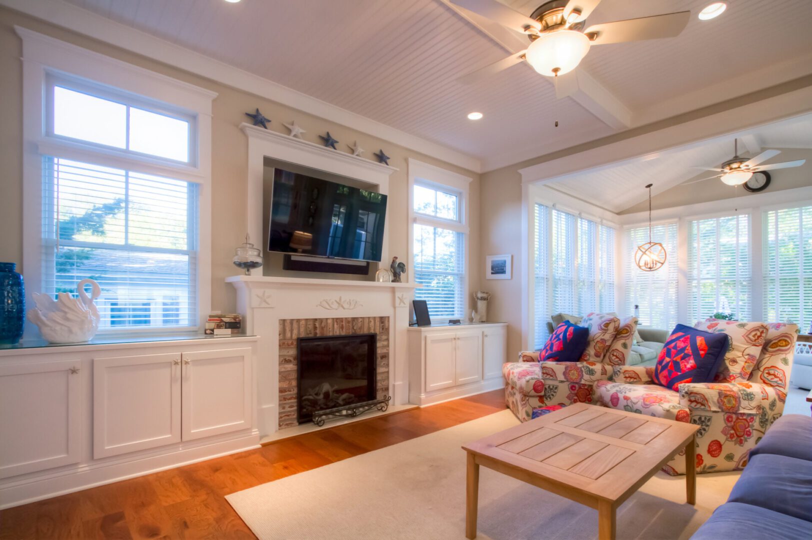 Coastal living room with fireplace and TV.