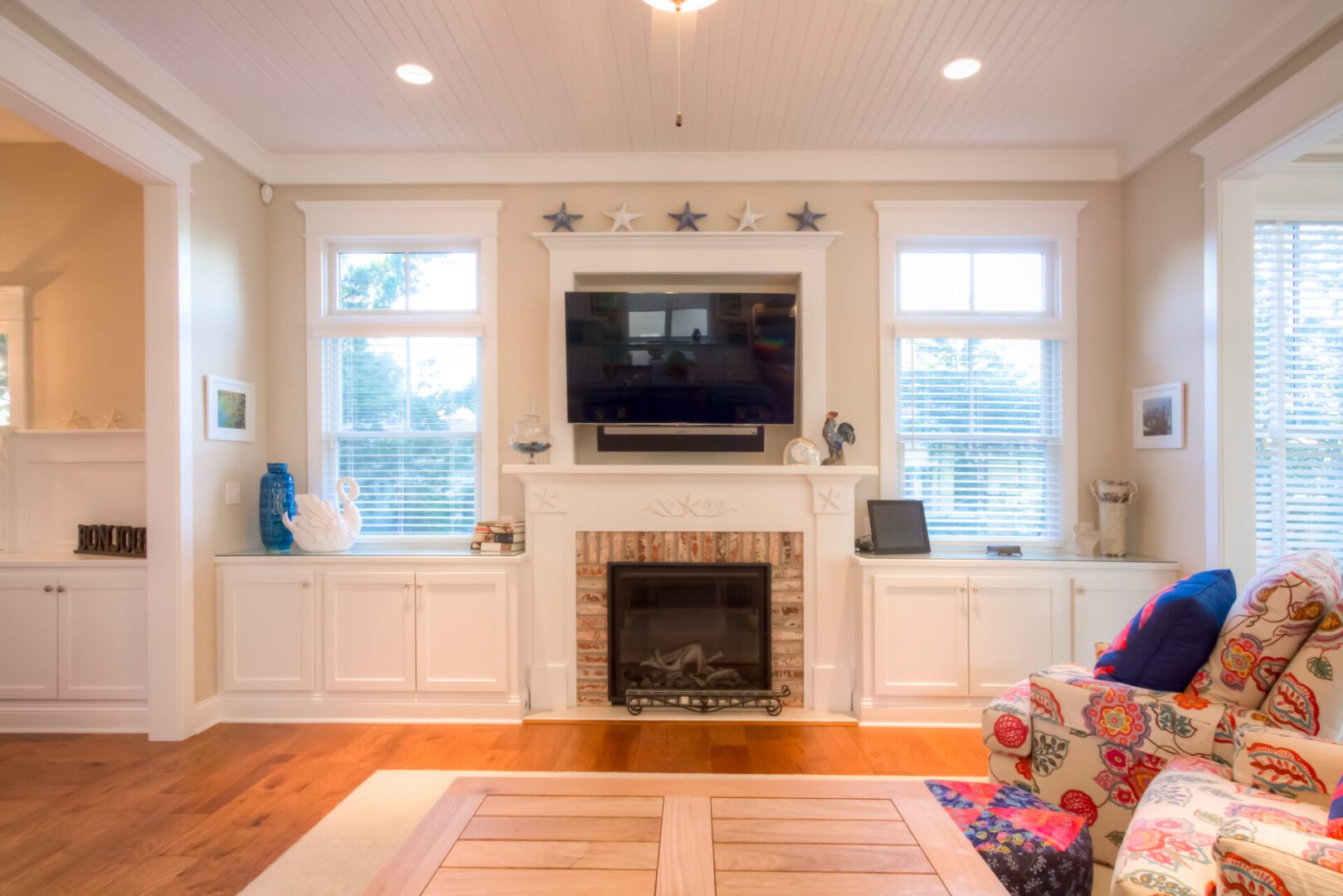Living room with fireplace and flat-screen TV.