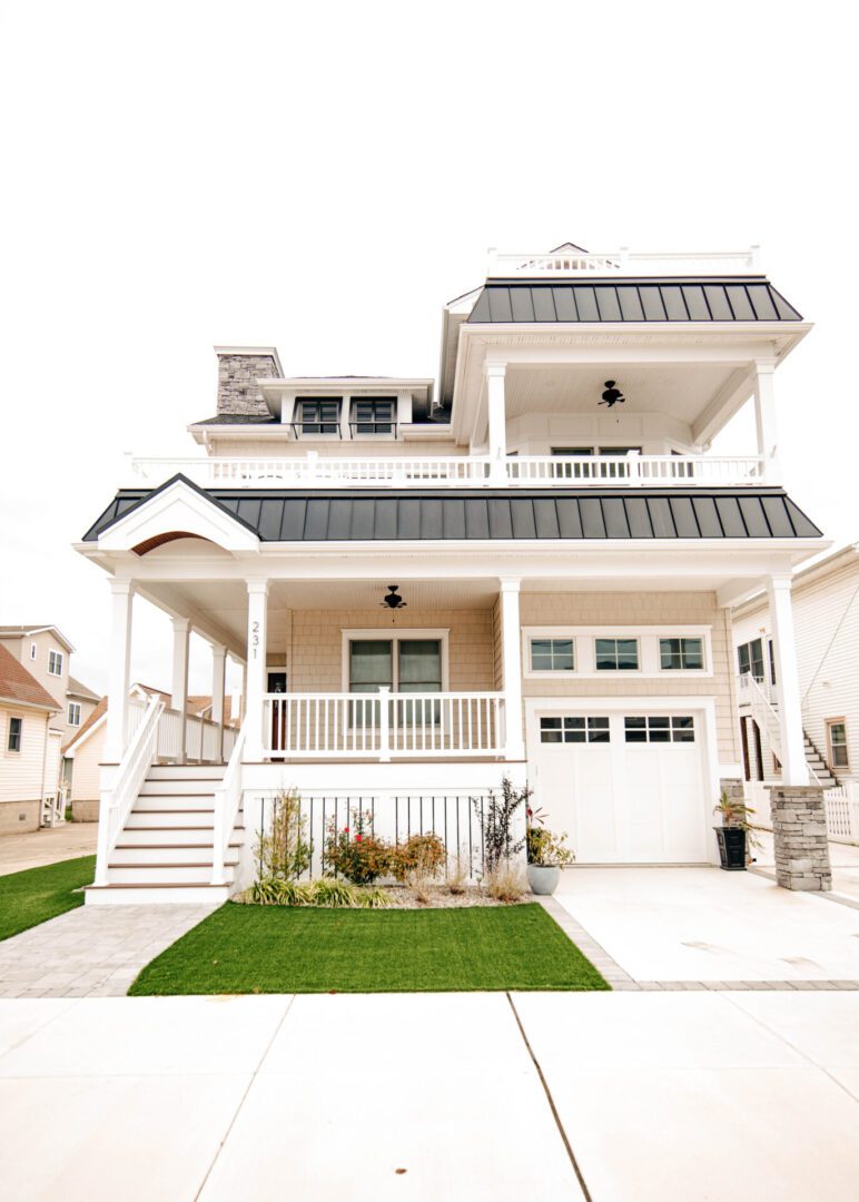 Two-story beach house with porch.