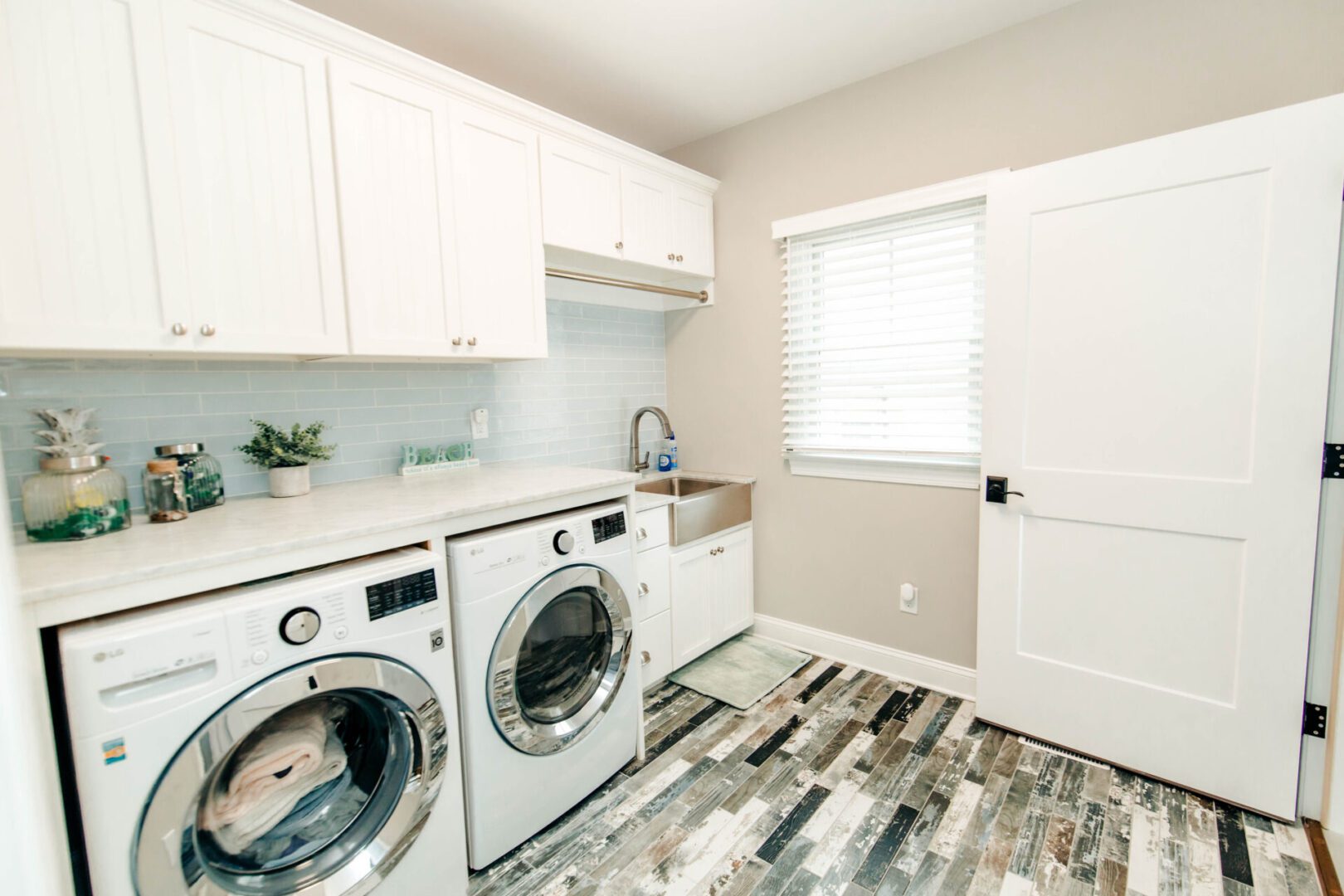 Bright laundry room with washer and dryer.