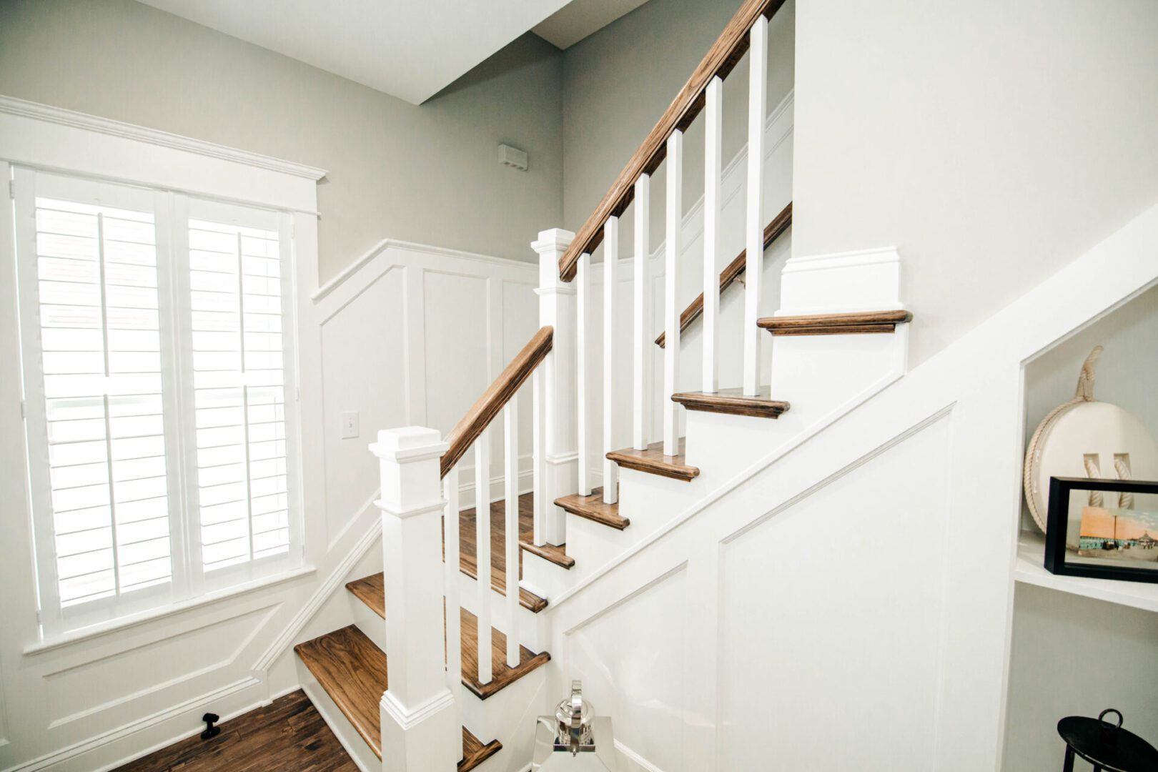 White staircase with dark wood accents.