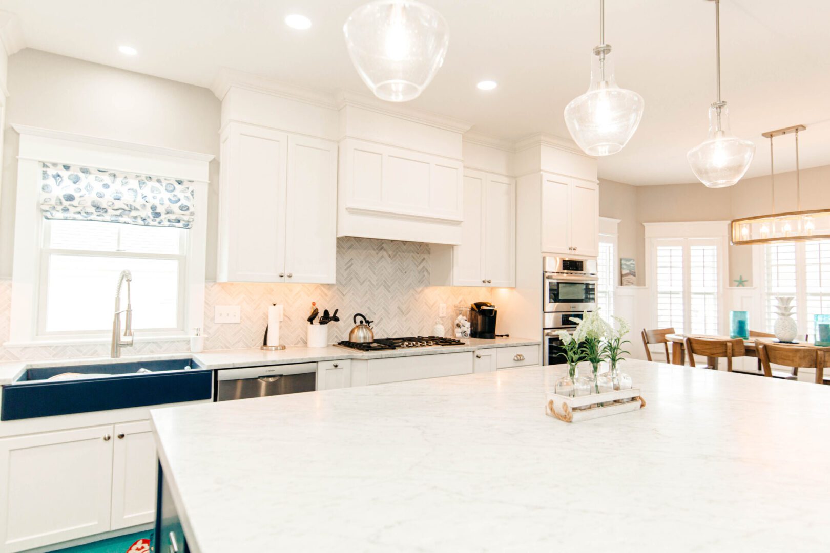 Bright white kitchen with marble island.
