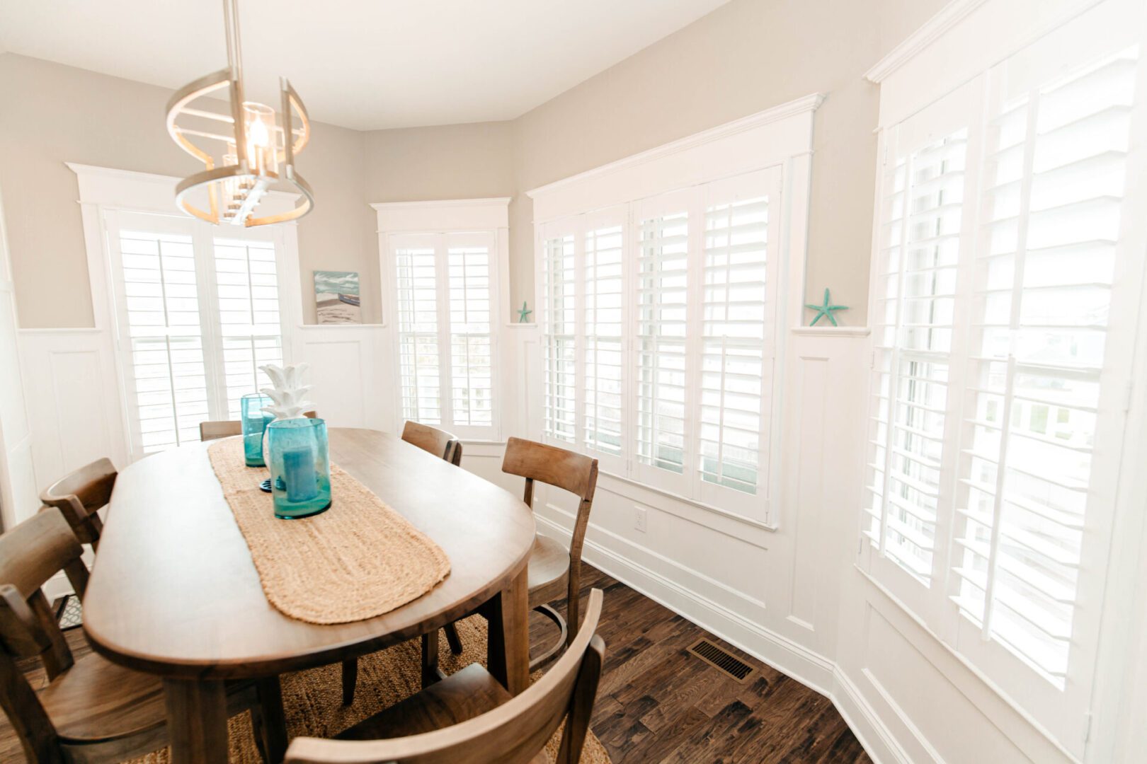 Bright dining room with white shutters.