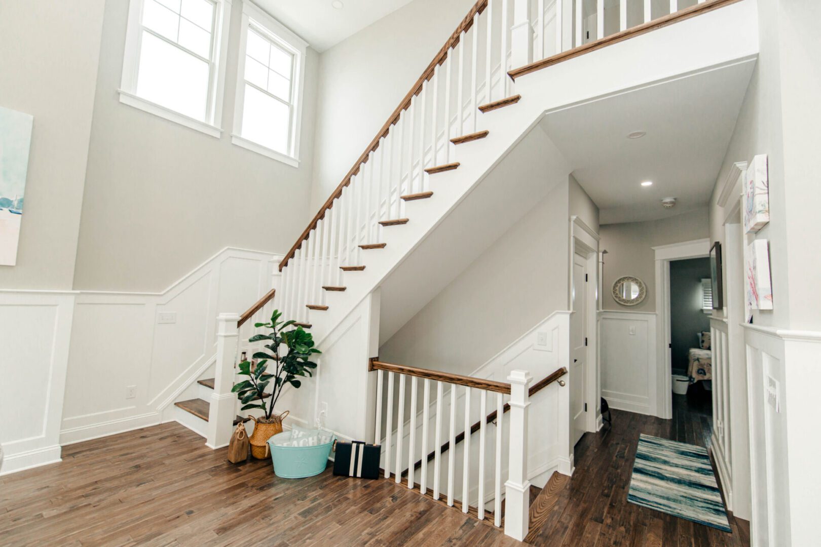 White and wood staircase in home.
