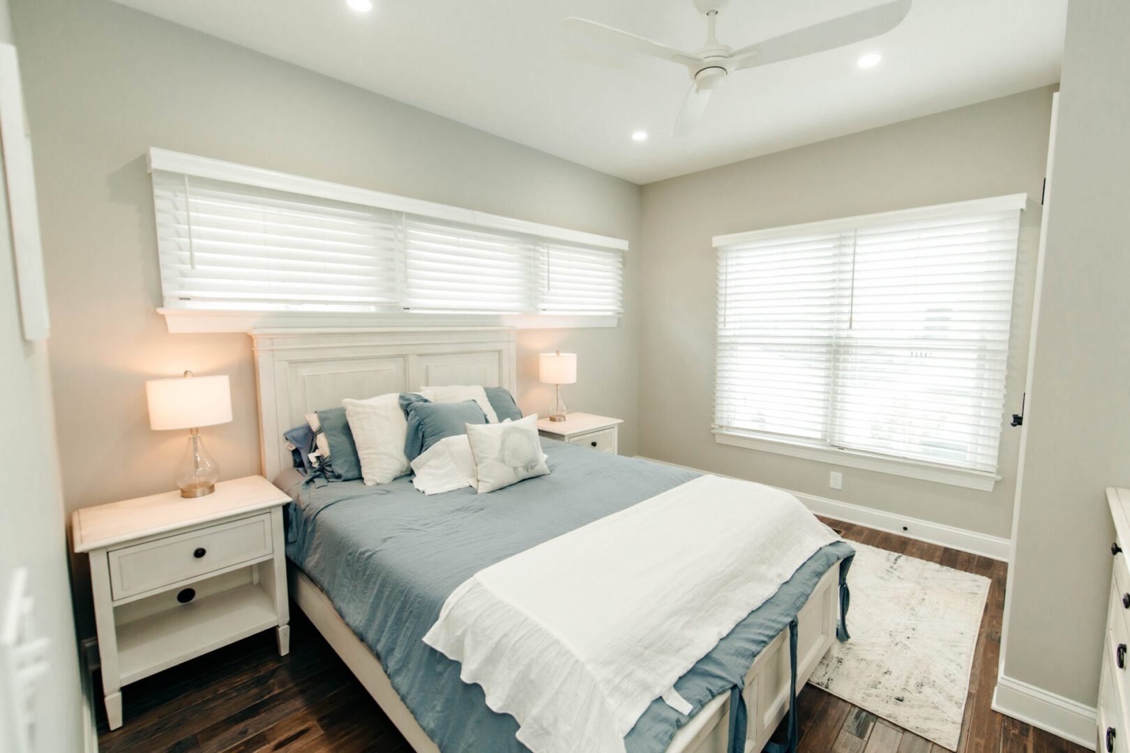 Beach-style bedroom with white bed.