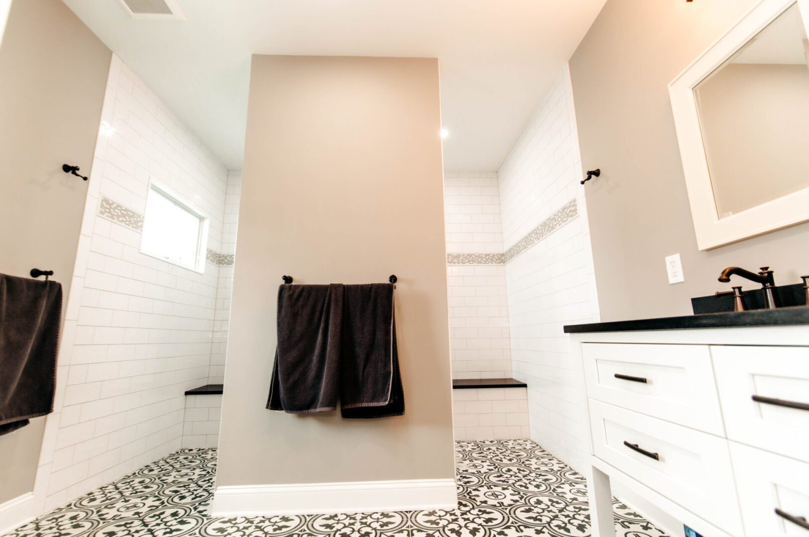 Elegant bathroom with patterned tile floor.