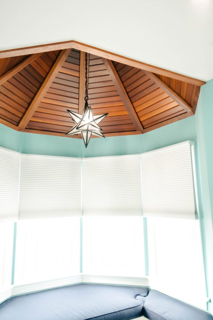Star light fixture in bay window.