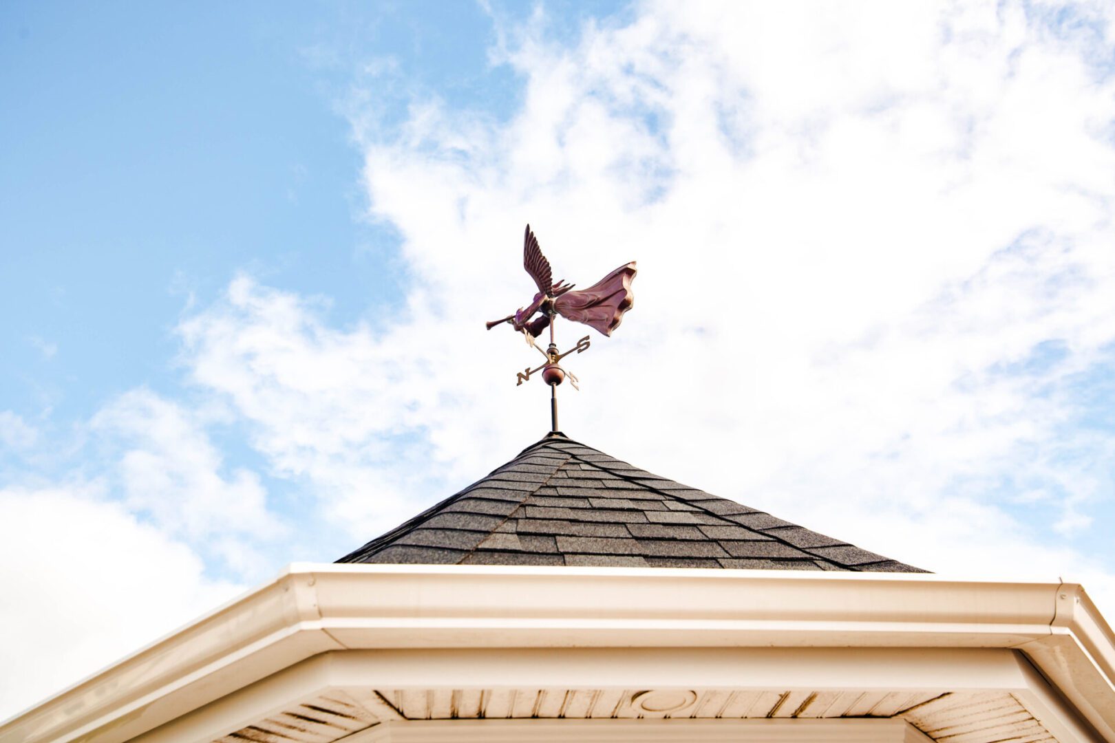 Angel weathervane atop a roof.