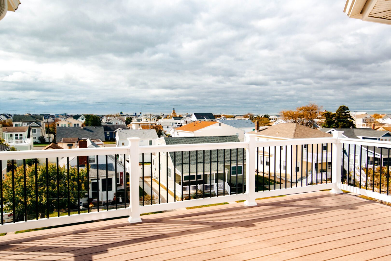Deck overlooking houses and ocean view.