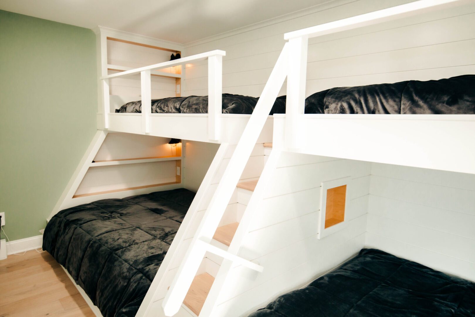 White bunk beds with built-in shelves.