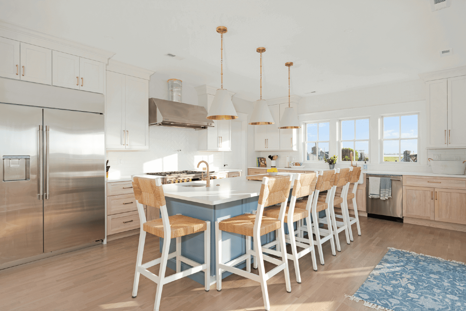 Bright kitchen with island and bar stools.