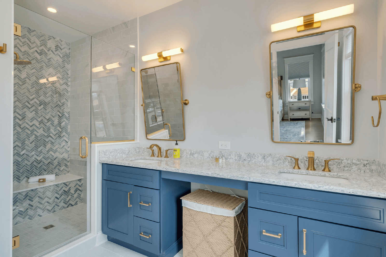 Modern blue bathroom with gold fixtures.