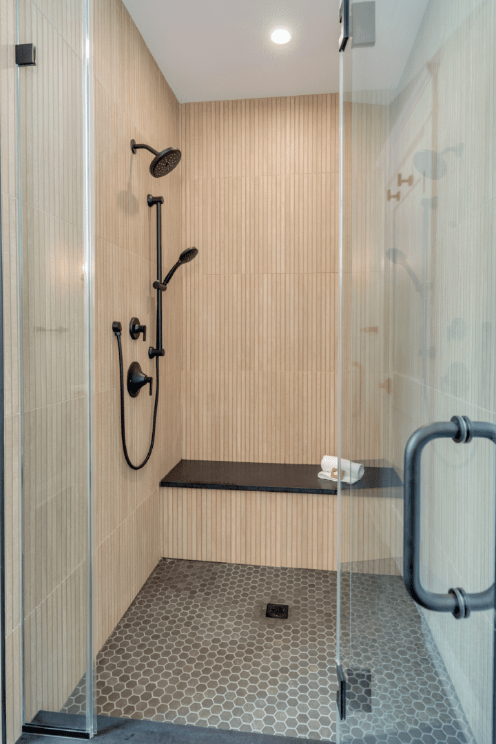 Modern walk-in shower with built-in seat.