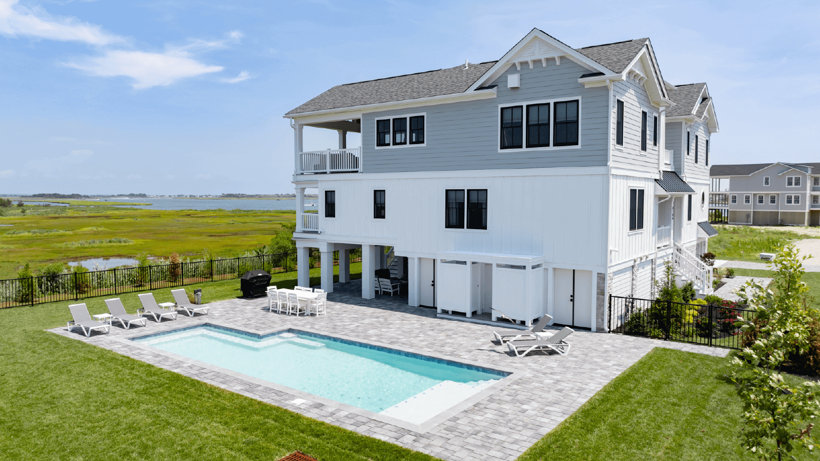 Beach house with pool and patio.